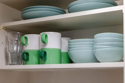 a shelf with cups and plates and bowls on it at \u4e80\u67095\u4e01\u76ee302 in Tokyo