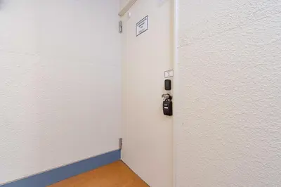 a room with a white door with a camera on it at \u4e80\u67095\u4e01\u76ee302 in Tokyo