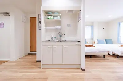 a bathroom with a sink and a bed in a room at \u4e80\u67095\u4e01\u76ee302 in Tokyo