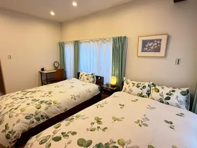 a bedroom with two beds and a window at Skytree-House\u6771\u5411\u5cf6 in Tokyo