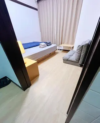 a small bedroom with a bed and a chair at Shinmei Tokyo Omori in Tokyo