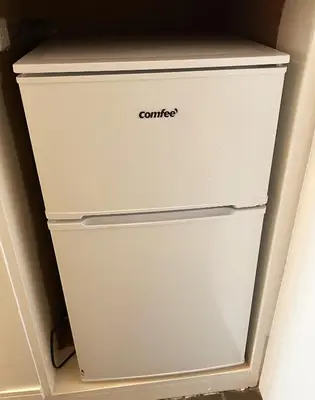 a white refrigerator with the word contact written on it at Shinmei Tokyo Omori in Tokyo