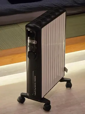 a black appliance sitting on a stand on wheels at Sumika House in Asakusa , 5 minutes walk to asakusa ST ATION 5 bedrooms, 2 living room 2kitchen 4toilet 2bathroom 2washmachine 2fridge Newly renovated with ultra-fast WiFi in Tokyo
