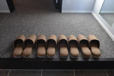 a row of brown shoes sitting on a shelf at \u30a2\u30fc\u30d9\u30a4\u30f3\u65b0\u5bbf\u795e\u697d\u5742 in Tokyo