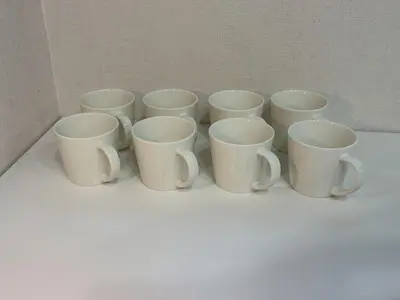 a group of white cups sitting on a table at EASE Shinjuku in Tokyo