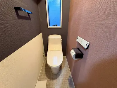 a small bathroom with a toilet and a window at EASE Shinjuku in Tokyo