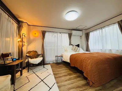 a bedroom with a bed and a desk and window at Shimokitazawa Cozy Apartment 202 in Tokyo