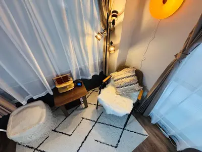 a room with a window with a chair and a table at Shimokitazawa Cozy Apartment 202 in Tokyo