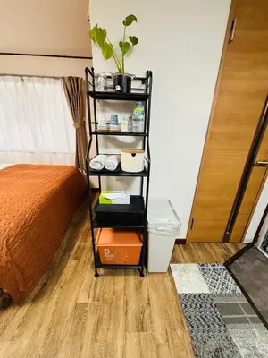 a shelf with a plant on it next to a bed at Shimokitazawa Cozy Apartment 202 in Tokyo
