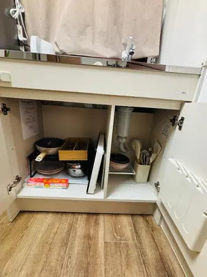 a kitchen pantry with a cabinet filled with utensils at Shimokitazawa Cozy Apartment 202 in Tokyo