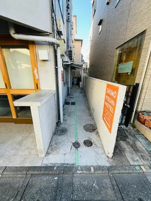 an empty alley with a sign on the side of a building at Shimokitazawa Cozy Apartment 202 in Tokyo