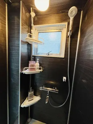 a bathroom with a shower and two sinks and a window at Shimokitazawa Cozy Apartment 202 in Tokyo