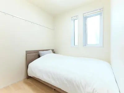 a white bedroom with a bed and a window at \u30a2\u30f3\u30c9\u30b9\u30c6\u30a4\u5927\u5cf67\u4e01\u76ee in Tokyo