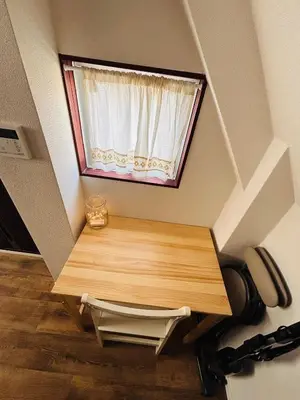 a small window in a room with a wooden table at Shimokitazawa Cozy Apartment 401 in Tokyo