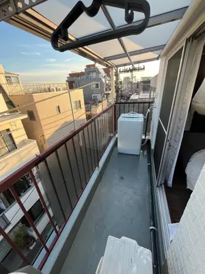 a balcony with a table and a refrigerator at Shimokitazawa Cozy Apartment 401 in Tokyo