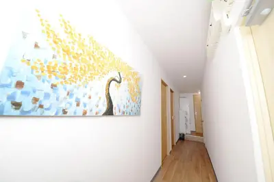 a hallway with a painting on the wall at ACT Residence 101 2\u5ba41\u30b7\u30e3\u30ef1\u30c8\u30a4\u30ec\u65b0\u5bbf\u6587\u5316\u30bb\u30f3\u30bf\u30fc\u8fd1\u96a3 in Tokyo