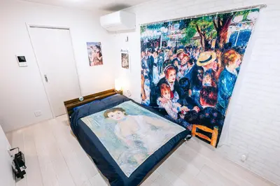 a bed in a room with a painting on the wall at Pierre-Auguste Renoir Tokyo Shibuya Shinjyuku 7min Free Wifi New Open in Tokyo