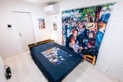 a bed in a room with a painting on the wall at Pierre-Auguste Renoir Tokyo Shibuya Shinjyuku 7min Free Wifi New Open in Tokyo
