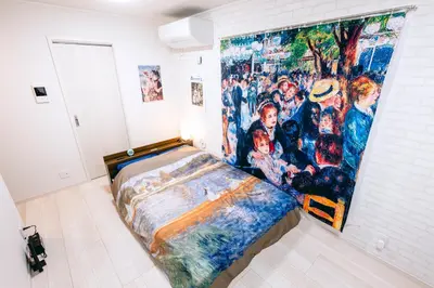 a bedroom with a large painting on the wall at Pierre-Auguste Renoir Tokyo Shibuya Shinjyuku 7min Free Wifi New Open in Tokyo