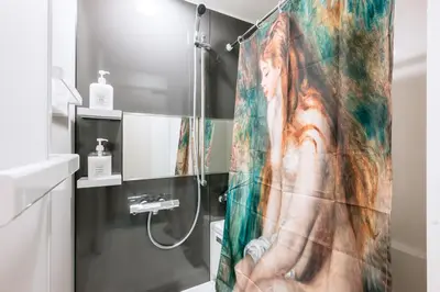 a shower curtain with a picture of a woman at Pierre-Auguste Renoir Tokyo Shibuya Shinjyuku 7min Free Wifi New Open in Tokyo