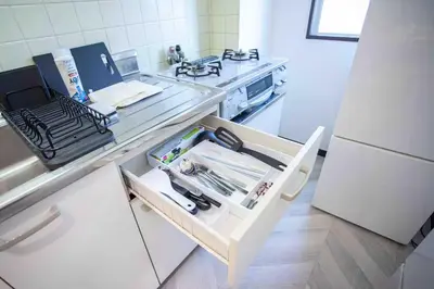a kitchen with a counter with a drawer and a refrigerator at Skytree View Heights in Tokyo