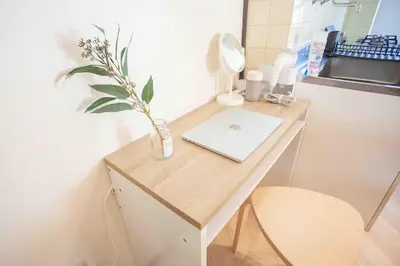 a bathroom with a desk with a laptop on it at Skytree View Heights in Tokyo
