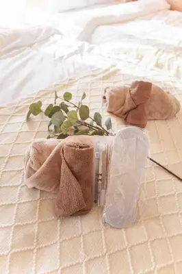 a towel and a bottle on a bed at Skytree View Heights in Tokyo