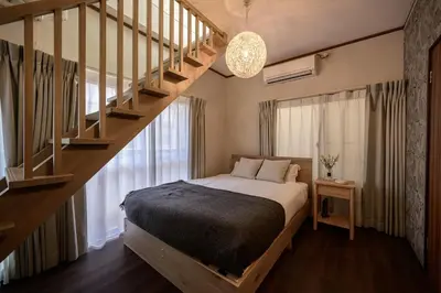 a bedroom with a bed and a staircase at Ueno Asakusa Area Spacious 90sqm Home Comfortable Tokyo Stay Up to 8 Guests in Tokyo