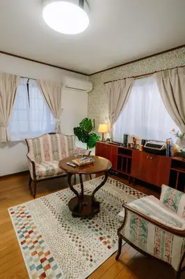 a living room with a table and a couch at Kimiko Jujo House - Local Art Stay 11 min Shinjuku in Tokyo
