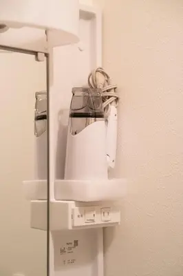 a white blender is hanging on a wall at Kimiko Jujo House - Local Art Stay 11 min Shinjuku in Tokyo