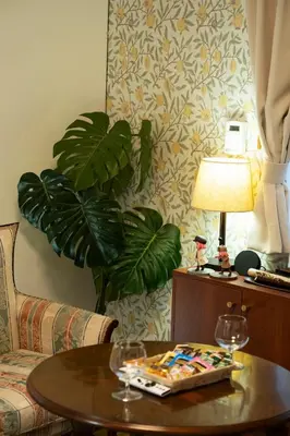 a living room with a table with a lamp and a plant at Kimiko Jujo House - Local Art Stay 11 min Shinjuku in Tokyo