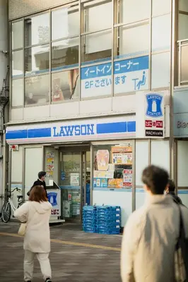 a group of people walking in front of a building at Kimiko Jujo House - Local Art Stay 11 min Shinjuku in Tokyo