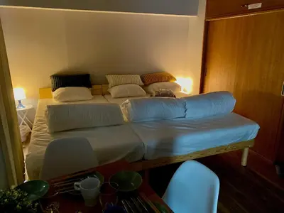a large bed in a room with a table at ShinjukuCityStay 525 in Tokyo