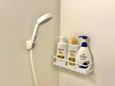 a bathroom with a toothbrush and cleaning products on a shelf at ShinjukuCityStay 525 in Tokyo