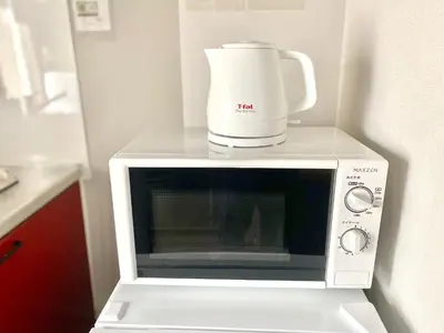 a coffee maker sitting on top of a microwave at ShinjukuCityStay 525 in Tokyo