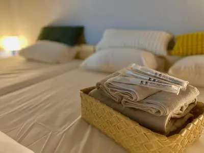 a basket of folded towels sitting on a bed at ShinjukuCityStay 525 in Tokyo
