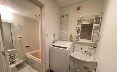 a small white bathroom with a sink and a tub at Prime Shinjuku - 12min to Kabukicho - Quiet Park Area - Entire House - 3BD 6Beds - 70 sqm 750 sqft in Tokyo