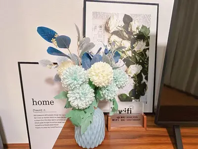 a vase filled with flowers sitting on a table at Newly built house with free parking, 3 minutes walk from Shinkoiwa Station in Tokyo