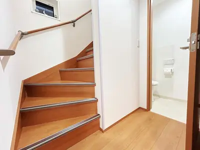 a staircase in a house with wooden steps at Newly built house with free parking, 3 minutes walk from Shinkoiwa Station in Tokyo