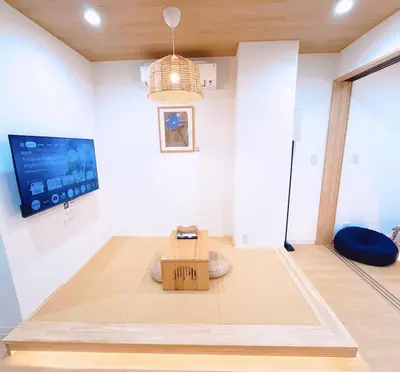 a room with a table and a tv on the wall at M101 5-minute walk from Minowa Station on the Hibiya Line, straight to Ueno, Akihabara, Ginza in Tokyo