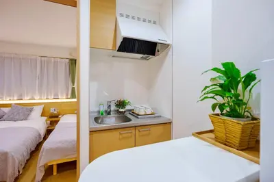 a small room with two beds and a sink at M201 Hibiya Line, 5-minute walk to Minowa ! Straight line to Ueno, Akihabara ,and Roppongi! Family room for 5-6 people! in Tokyo