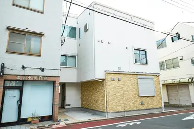 an apartment building on the corner of a street at Edelweiss 301 in Tokyo