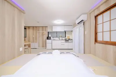 a large room with a kitchen and a large bed at ohayo\u5c0f\u5c71\u53f0 in Tokyo