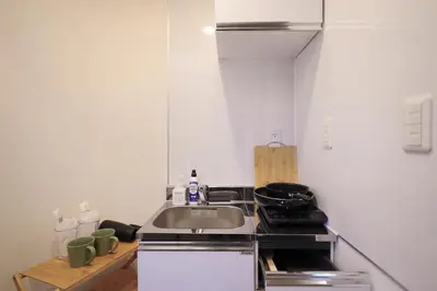 a small kitchen with a sink and a stove at ohayo\u5c0f\u5c71\u53f0 in Tokyo