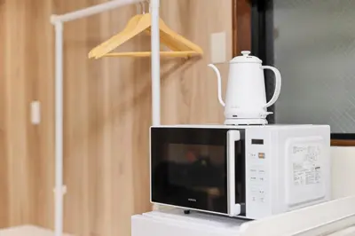 a white blender sitting on top of a microwave at ohayo\u5c0f\u5c71\u53f0 in Tokyo
