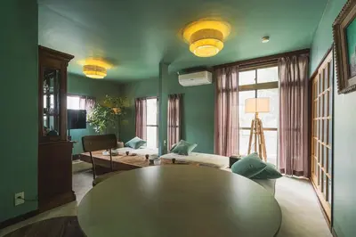 a living room with a table and a couch at Kameido Saryo in Tokyo
