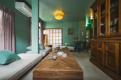 a living room with a couch and a table at Kameido Saryo in Tokyo