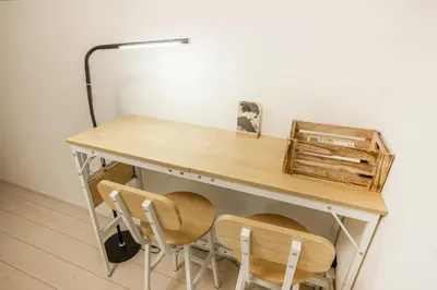 a desk with two chairs and a lamp at Shinjuku Area Top-Tier Luxury, 4 min Walk to Station, Stay in a Traditional Japanese Beauty Ukiyo-e Art Villa, Shinjuku 13 min, Sleeps 8, Entire New 3BR House, 60sqm, Free Parking, Roppongi and Tsukiji direct access in Tokyo