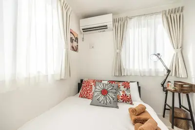 a white bedroom with a bed and a window at Shinjuku Area Top-Tier Luxury, 4 min Walk to Station, Stay in a Traditional Japanese Beauty Ukiyo-e Art Villa, Shinjuku 13 min, Sleeps 8, Entire New 3BR House, 60sqm, Free Parking, Roppongi and Tsukiji direct access in Tokyo