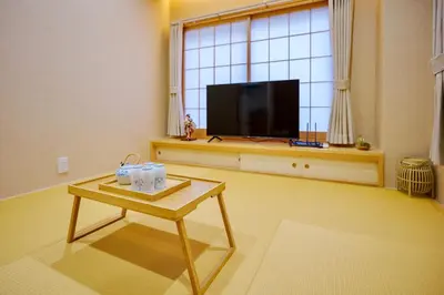 a living room with a coffee table and a flat screen tv at M301 5 minutes walk from Minowa Station on the Hibiya Line! Direct access to Ueno, Akihabara, Tsukiji Market, Ginza! Family room for 5-6 people! in Tokyo